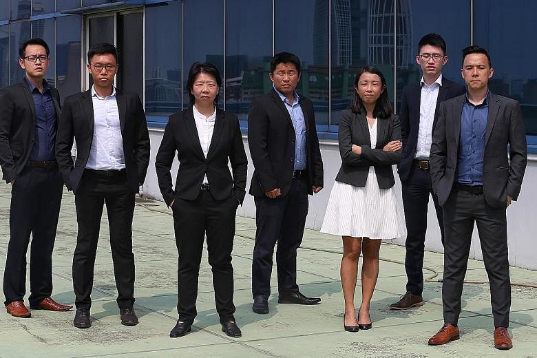 Deputy Assistant Commissioner Aileen Yap (third from left), assistant director of the Specialised Commercial Crime Division in the Commercial Affairs Department, with the team of six officers across various departments in the police who helped set up