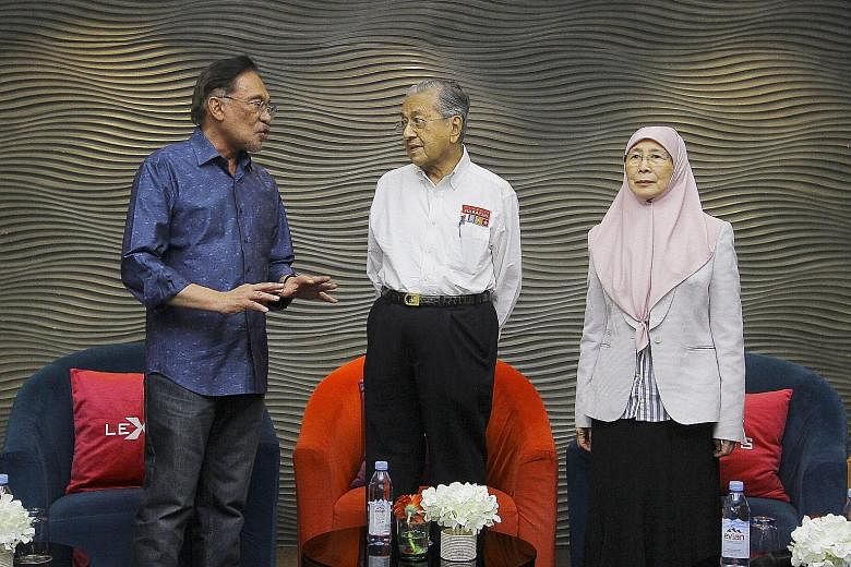 Malaysian Prime Minister Mahathir Mohamad, seen here with Datuk Seri Anwar Ibrahim and Deputy Prime Minister Wan Azizah Wan Ismail during a Parti Keadilan Rakyat retreat in Port Dickson on July 19, has said he has no plans for new ministers to be add
