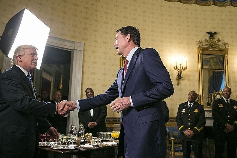 A January 2017 file photo of then FBI director James Comey (at right) meeting President Donald Trump in the White House. Mr Comey wrote memos after meeting Mr Trump early in his presidency, saying later that he wanted to document the encounters as he