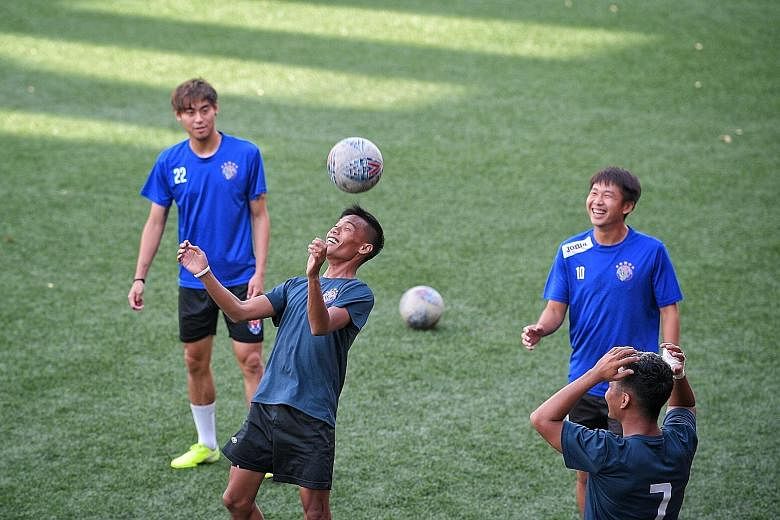 Warriors FC players training at Jurong East Stadium yesterday for their game against defending champions Albirex today. The FAS says club GM Paul Poh should vacate his post.