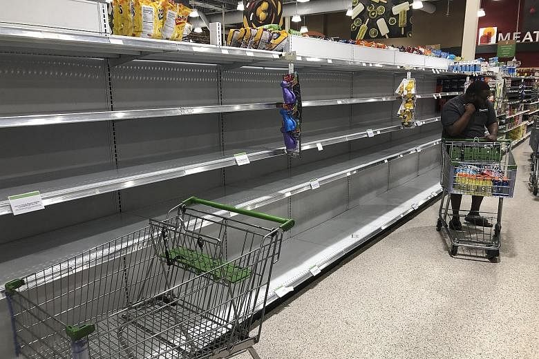 Shelves emptied of bottled water at a grocery store in Florida on Friday. US President Donald Trump has declared a state of emergency in Florida and authorised the Federal Emergency Management Agency to coordinate disaster-relief efforts in the state