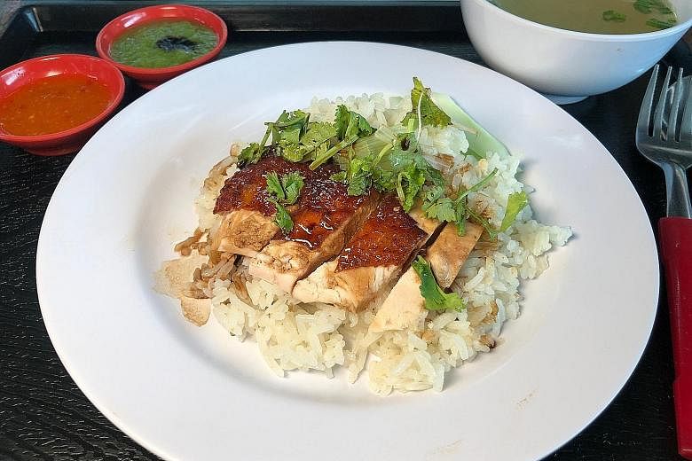 This $1.50 plate of chicken rice comes with a decent amount of rice, four slices of breast meat, cucumber, coriander and a bowl of soup.