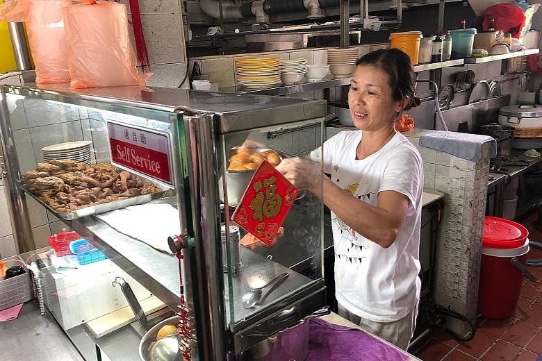 To make her pig's organ soup, stall owner Yang Yue Ying (above) marinates the pork liver and pork slices in tapioca starch. 