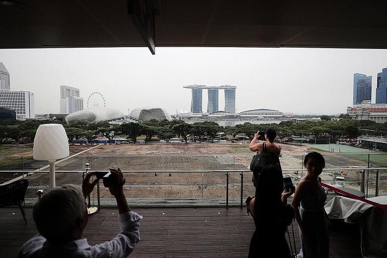 The Padang, photographed last Wednesday, with patches of brown following last month's National Day Parade. Work is under way to returf the expanse ahead of the Singapore Grand Prix, which will be held in the area later this month. 
