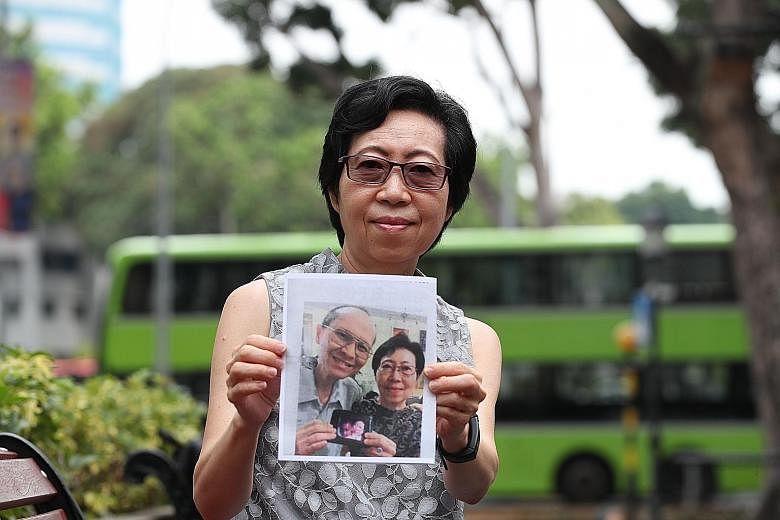 Mrs Carol Lye holding a photograph of herself and her late husband Caesar Lye, who helped dozens of people in need over many years. ST PHOTO: TIMOTHY DAVID