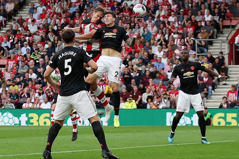 Southampton's 1.99m Jannik Vestergaard towering above Manchester United's Victor Lindelof to equalise in their 1-1 draw at St Mary's Stadium yesterday. It was the defender's first goal for his club. PHOTO: REUTERS