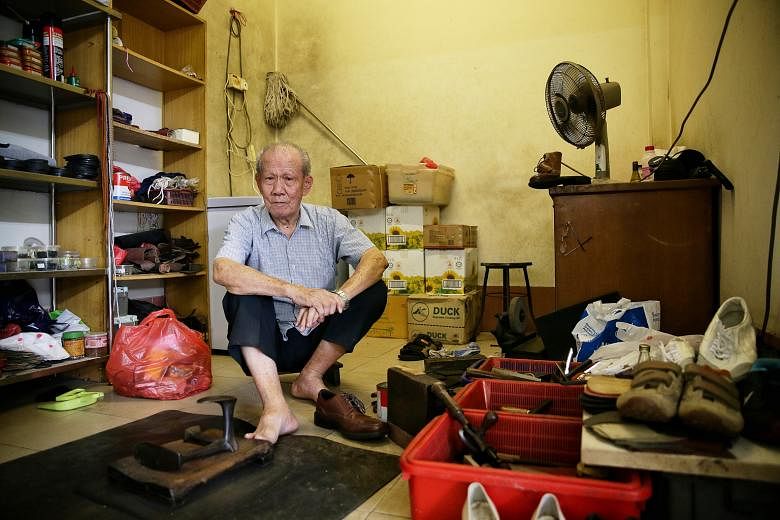 Mr Low Poh Lye at his shoe repair shop in Bukit Timah Market and Food Centre. The octogenarian still works each morning "to pass the time, have some fun", even though he does not need the income.