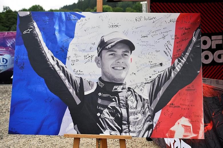 Condolence messages are written on a poster of Formula Two driver Anthoine Hubert, who died in a crash at the Belgian GP on Saturday.