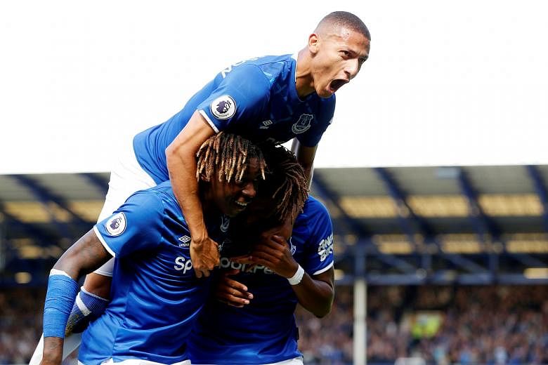 Everton forward Richarlison, joined by teammate Moise Kean, celebrating their second goal scored by Alex Iwobi (bottom right). The Brazilian himself scored the other two, including an 80th-minute winner. PHOTO: REUTERS