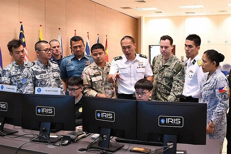 Participants in the Asean-US Maritime Exercise using the Republic of Singapore Navy's Information Fusion Centre Real-time Information-sharing System at the Changi Command and Control Centre yesterday.