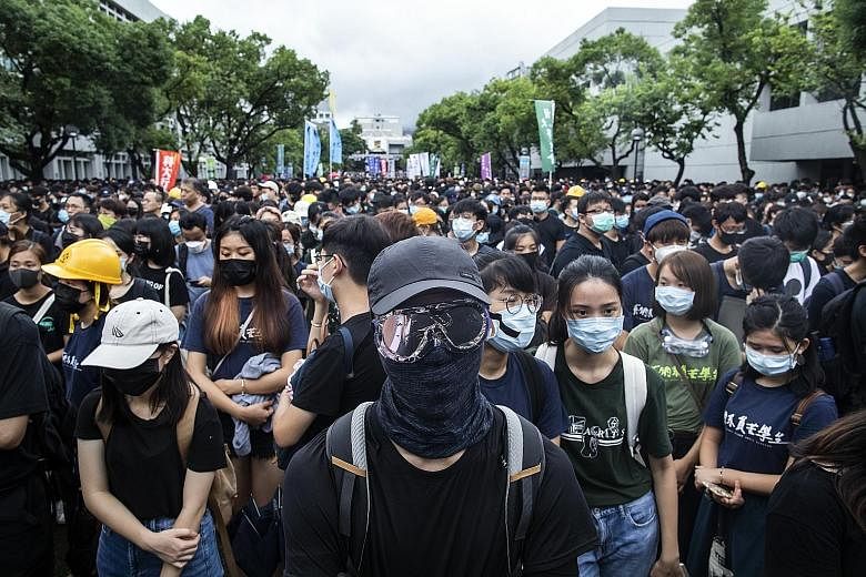 Student protesters dressed in black at Chinese University of Hong Kong during a class boycott yesterday. The city's students say they would give the government two weeks to respond to their demands for greater democracy before further escalating thei