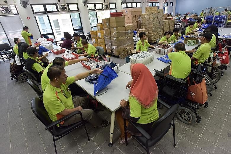 In this photo taken on Aug 30 last year, people from the SPD - the former Society for the Physically Disabled - packing bags for The Straits Times Run. The Ministry of Manpower's annual Comprehensive Labour Force Survey found that community, social a