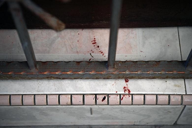 Blood stains on the doorstep of the unit in Block 191 Lorong 4 Toa Payoh. ST PHOTO: KUA CHEE SIONG