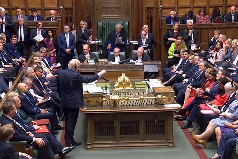 British Prime Minister Boris Johnson speaking in the House of Commons yesterday, as he faced a showdown with MPs who aimed to take control of the agenda to stop a no-deal Brexit. PHOTO: EPA-EFE
