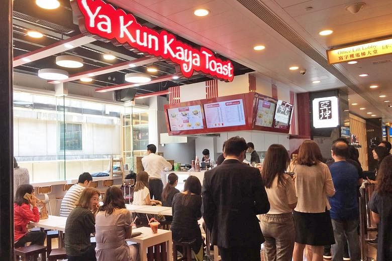 Ya Kun's outlet in Hong Kong's Admiralty financial district on its opening day in June. Sales at the outlet have been below expectations, says Ya Kun executive chairman Adrin Loi, but business is still holding up during the week, thanks to the Admira