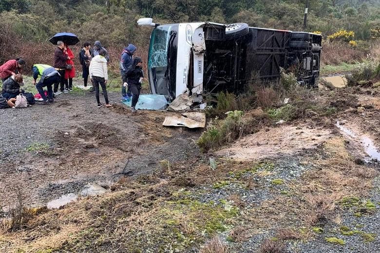 The bus carrying 27 people flipped to the opposite side of the road on State Highway 5 near Rotorua, a popular destination for tourist groups from China. PHOTO: REUTERS