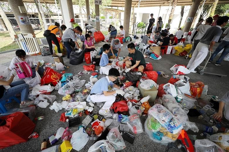 Tzu Chi Foundation volunteers sorting plastic items for recycling earlier this year. The new Act gives regulatory teeth to waste-reducing measures in three streams: e-waste, food waste and packaging waste, including plastics. ST FILE PHOTO