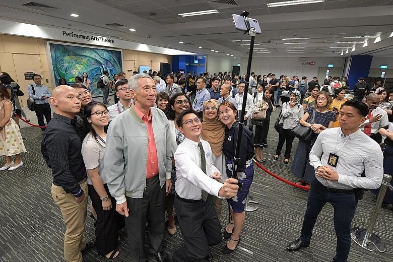 Prime Minister Lee Hsien Loong taking a photo with participants of the Singapore University of Social Sciences' inaugural ministerial dialogue. Among the issues covered during the dialogue were the value of lifelong learning and a university educatio