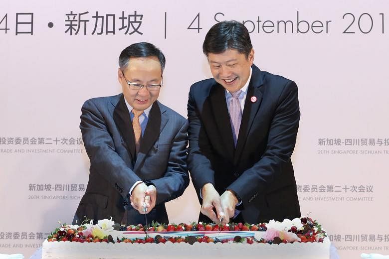 Minister in the Prime Minister's Office Ng Chee Meng (right) with Sichuan vice-governor Li Yunze at the cake-cutting ceremony of the 20th Singapore-Sichuan Trade and Investment Committee meeting at the Shangri-La Hotel yesterday.