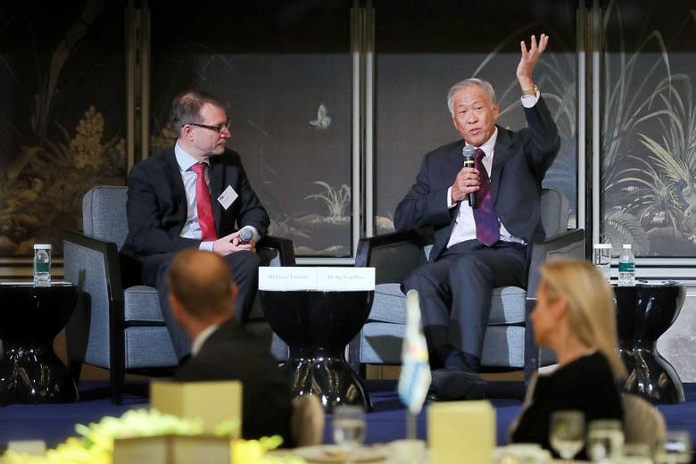 Defence Minister Ng Eng Hen (right) fielding questions during the question-and-answer session moderated by Dr Claus Trenner, the Singapore-German Chamber of Industry and Commerce board president, during yesterday's business luncheon at the Shangri-La