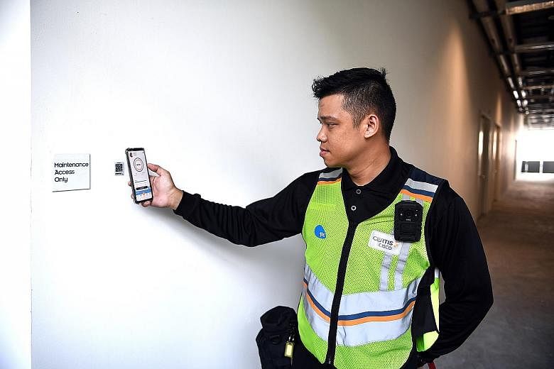 A Certis security officer using Argus, a mobile app, to send location reporting at Space@Tuas.