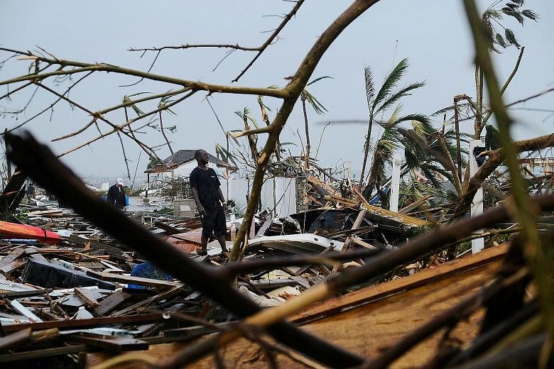 A resident surveying damage in the aftermath of Hurricane Dorian on the Great Abaco island town of Marsh Harbour, Bahamas, on Monday. At least 20 people have been killed and thousands remain missing after the most damaging storm to hit the island nat