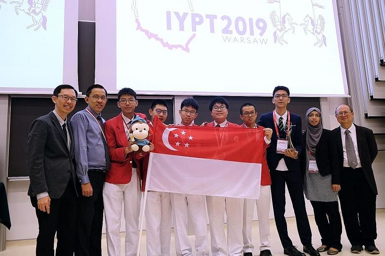 The Singapore team celebrating their win at the International Young Physicists Tournament at the University of Warsaw in Poland on July 12. The five students - (centre, from left) Raffles Institution's (RI) Max Tan Wei Han and Matthew Yar Kwok Jway, 