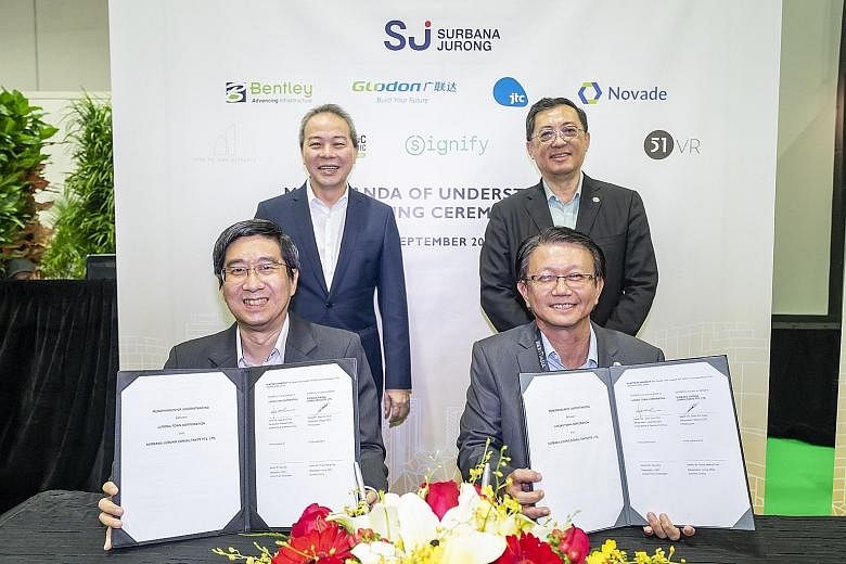 (Clockwise from back left) JTC chief executive Ng Lang, Surbana Jurong group CEO Wong Heang Fine, Surbana Jurong deputy CEO for infrastructure Seah Kim Huah and JTC assistant CEO for engineering and operations Heah Soon Poh at the signing of the memo