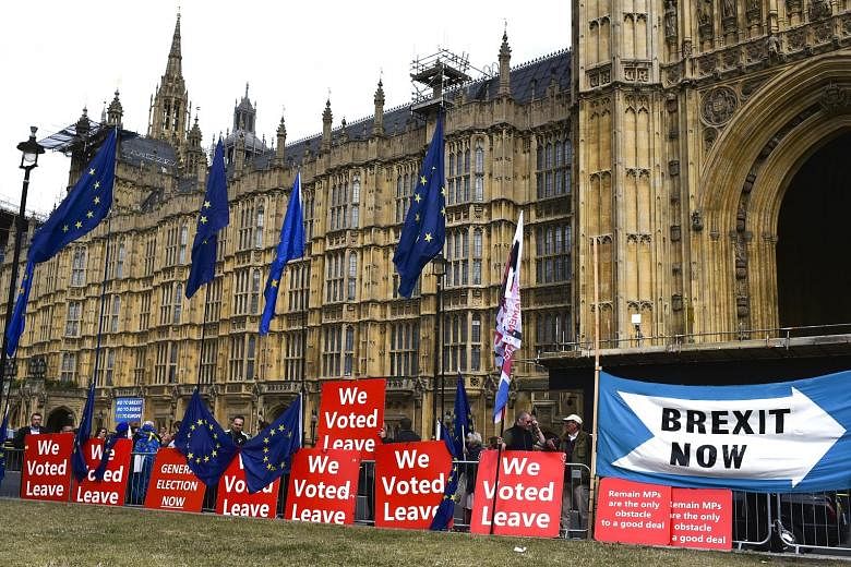 Pro-Brexit placards and European Union flags lining the outside of the Houses of Parliament in London on Thursday.