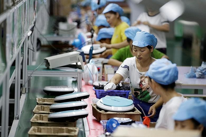 Workers making robotic vacuum cleaners at the production line of Matsutek's factory in Shenzhen. Mr Terry Wu (above), general manager of two Matsutek units in Shenzhen, said its new focus on the China market has been a huge success.