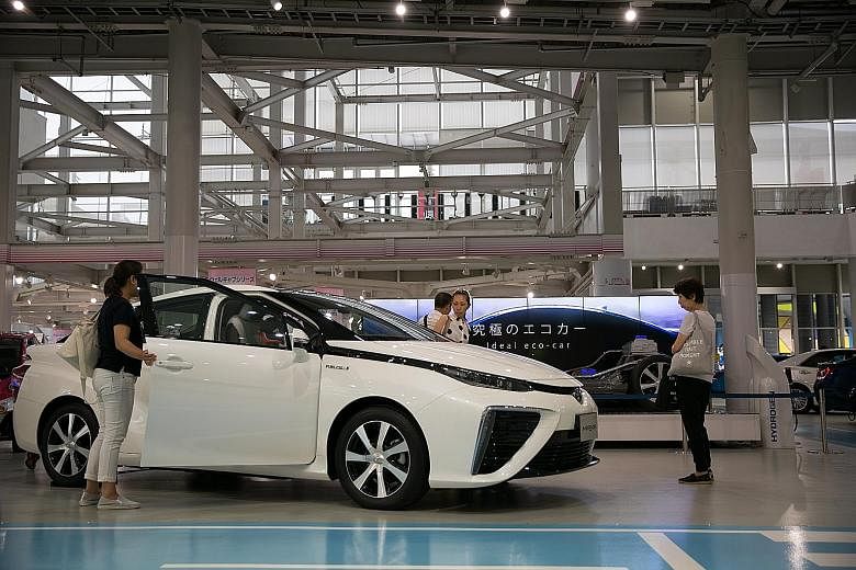 The hydrogen fuel cell-powered Toyota Mirai on display at a showroom in Tokyo. Hyundai distributor Komoco plans to bring in the Nexo, a fuel-cell crossover vehicle, for a trial in Singapore. The fuel-cell cars may be used as taxis to gauge robustness