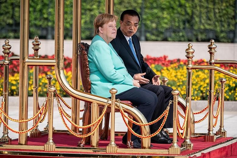 German Chancellor Angela Merkel at a welcome ceremony with Chinese Prime Minister Li Keqiang before their meeting at the Great Hall of the People in Beijing yesterday.