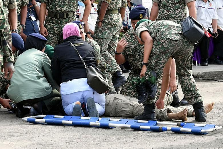 Military medics administering treatment to Major Mohd Zahir Armaya after he was shot at an army camp in Malaysia's Sabah state on Wednesday. Maj Zahir was due to serve as a UN peacekeeper in Lebanon in a few weeks. 