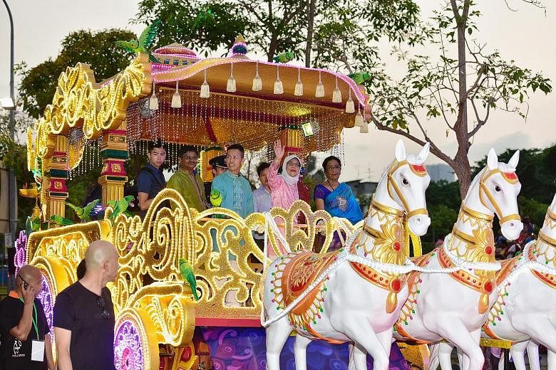 President Halimah Yacob waving from a float during a street parade at the Deepavali Light Up Ceremony in Little India's Race Course Road yesterday evening. The event marks the start of Deepavali celebrations in Little India. An estimated 5,000 people