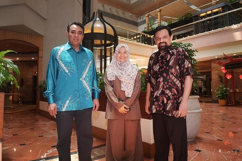 Community outreach officer Siti Nur Hasanah Mohd Yusoff with Religious Rehabilitation Group (RRG) vice-chairman Mohamed Ali (far left) and RRG secretary Mohamed Feisal Mohamed Hassan. They were among 400 volunteers whose efforts were recognised yeste