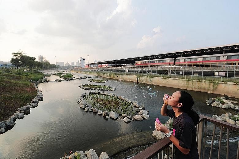 Bishan resident Sharon Quek, 14, having fun at the upgraded stretch of the Kallang River yesterday. Features to beautify the area include a naturalised slope, small islands with plants, and water cascades that help the water to flow from a higher ele