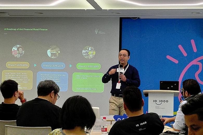 Participants at Ant Financial's Tech Innovator Workshop in Hangzhou two weeks ago. Ant Financial is the fintech affiliate of Alibaba. Ms Utari Octavianty at Freshippo, Alibaba's robot-driven supermarket, in Hangzhou, on Aug 28, under the Tech for Inc