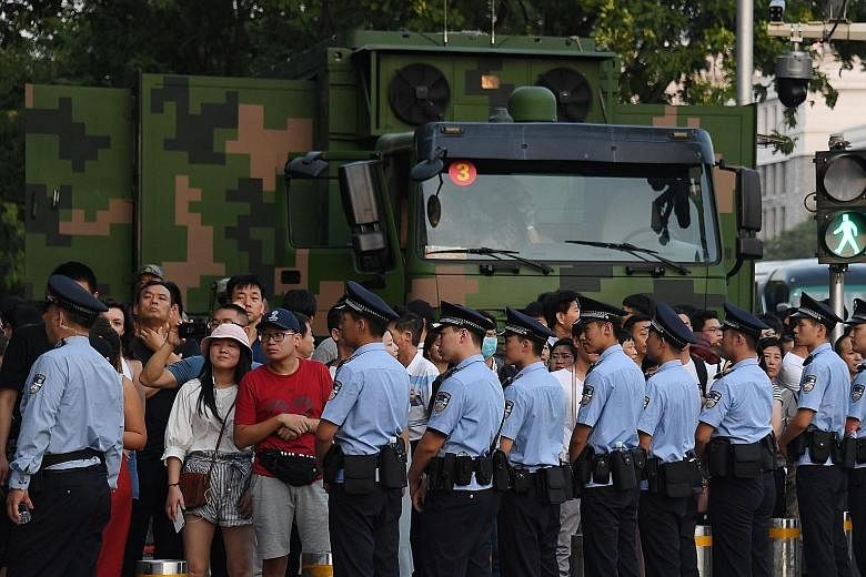 Chinese police blocking off a street corner near Tiananmen Square on Saturday, ahead of an overnight rehearsal for a military parade to mark the country's 70th anniversary on Oct 1.