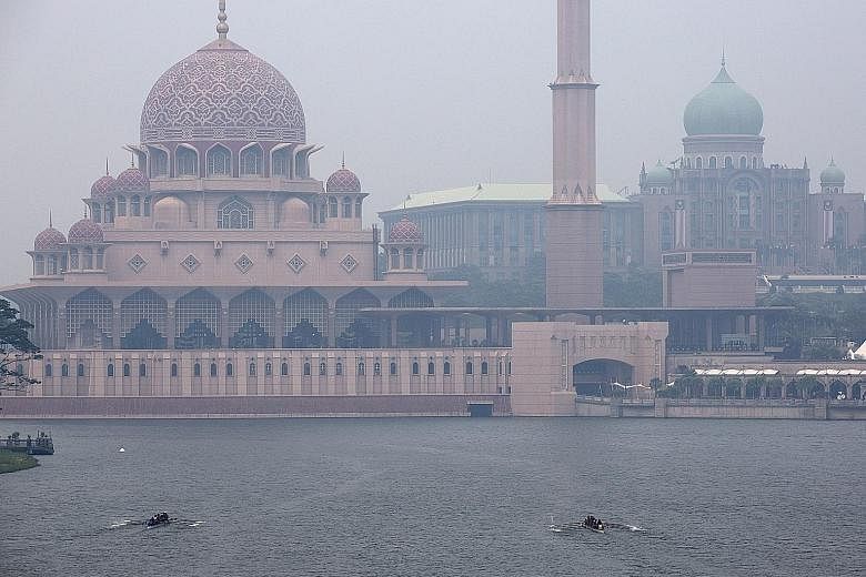Buildings in Putrajaya shrouded in haze yesterday. Several areas in Malaysia, especially on the west coast of the peninsula and west Sarawak, were affected by the haze due to the increase in hot spots in places like Sumatra, Indonesia.