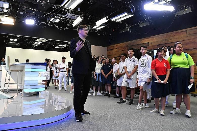 Mr Jonathan Matthew Roberts, creative director at EMTM Video, showing the students around a studio yesterday. The 40 secondary school students were drawn from among more than 300 participants of N.E.mation!, an inter-school digital animation competit