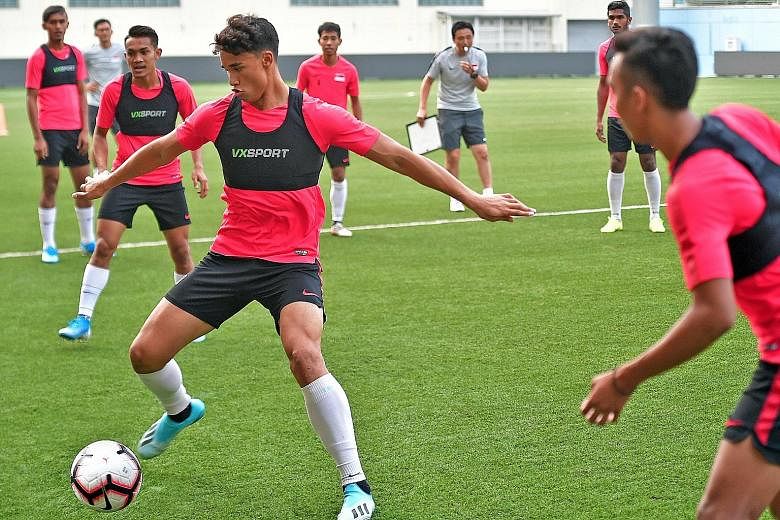 Ikhsan Fandi on the ball during training ahead of the World Cup qualifier against Palestine. The striker is relishing the opportunity of shouldering Singapore's scoring responsibilities at the tender age of 20.