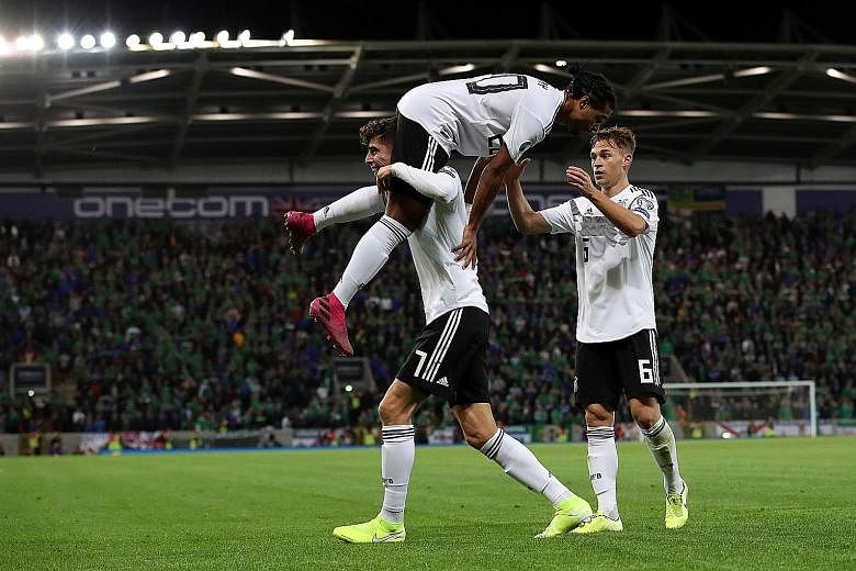 Germany's Serge Gnabry being congratulated by Kai Havertz (left) and Joshua Kimmich after scoring in the 2-0 Euro 2020 qualifying win over Northern Ireland on Monday. The Bayern Munich forward has now netted nine goals in 10 international appearances