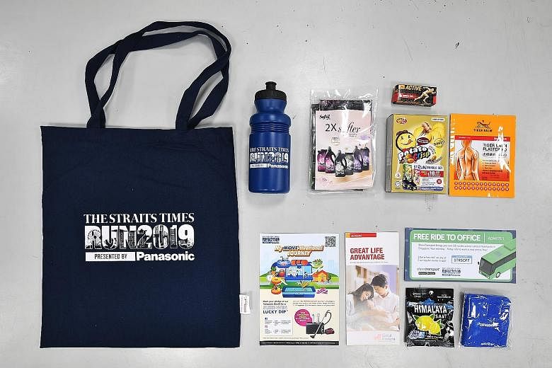 This year's race pack "haul" (above) includes two New Balance T-shirts, a water bottle, a wristband, muscle rub and fabric softener. Volunteers from LeCharity and people with disabilities (right) packing the race packs at SPD Ability Centre on Monday