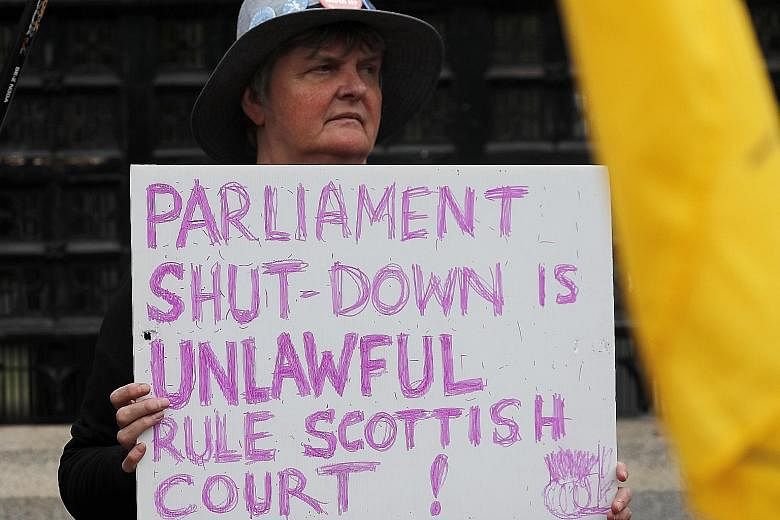A pro-European Union protester in front of the Houses of Parliament entrance in London yesterday. Britain's Parliament was suspended on Monday until Oct 14, a move opponents argued was designed to thwart their attempts to scrutinise Prime Minister Bo