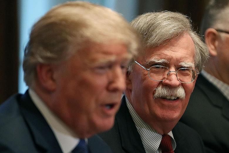In this file photo taken last year, US National Security Adviser John Bolton is seen with President Donald Trump. Mr Bolton was always an odd fit for Mr Trump, with fundamental differences on past policies.