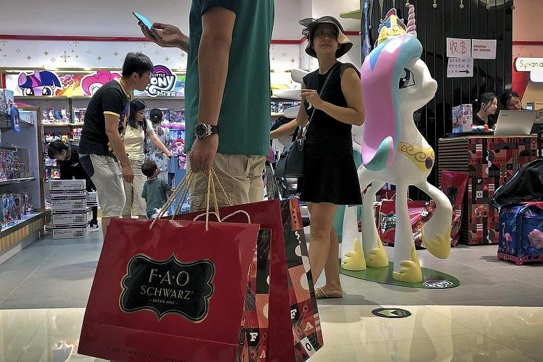 Shoppers at a Beijing outlet of US toy store chain FAO Schwarz in June. Over a quarter of American firms polled said they had redirected investments originally planned for China to other locations. PHOTO: ASSOCIATED PRESS