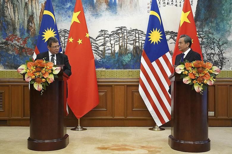 Malaysian Foreign Minister Saifuddin Abdullah (left) and Chinese State Councillor Wang Yi at their press conference following a meeting at the Diaoyutai State Guesthouse in Beijing yesterday.