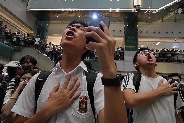 Protesters singing Glory To Hong Kong at a mall in the city on Wednesday. The anonymously penned tune, which first appeared on YouTube on Aug 31, has won a huge following among protesters.