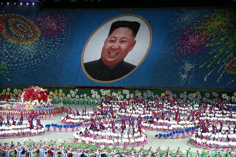 Performers holding up cards to form a portrait of North Korean leader Kim Jong Un during a Mass Games performance titled "The Land of the People" at the May Day Stadium in Pyongyang on Wednesday. The Mass Games performances, which North Korea has sta