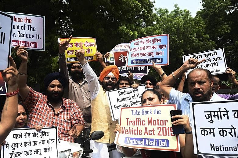 National Akali Dal president Paramjeet Singh Pamma (centre) with supporters of his political party rallying against India's new Motor Vehicle Act in New Delhi on Sunday.
